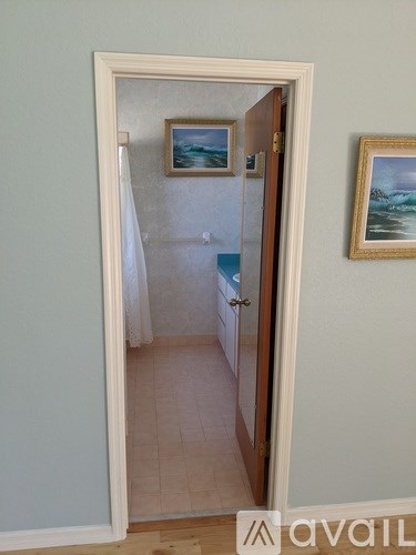 A hallway with a doorway leading to another room.