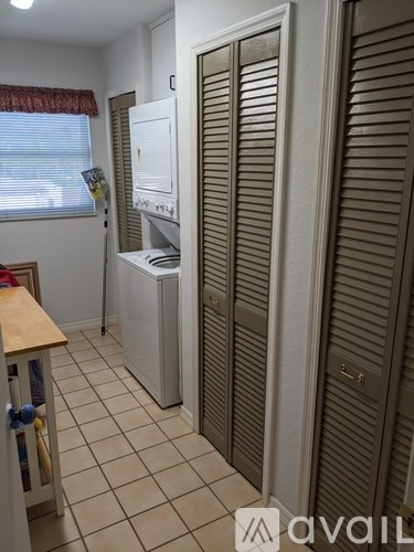 A kitchen with a white fridge and a white cabinet.