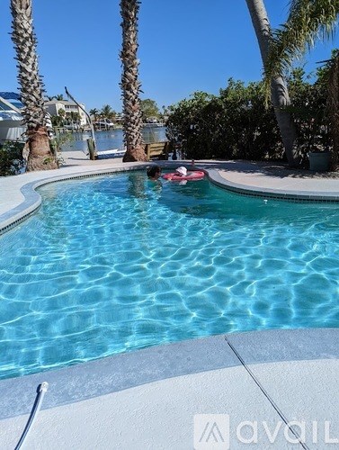 A person is floating on a pool raft.