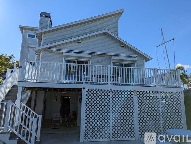 A house with a white deck and lattice fence.