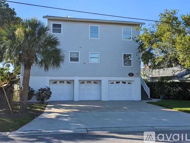 A two-story house with a garage and a driveway.
