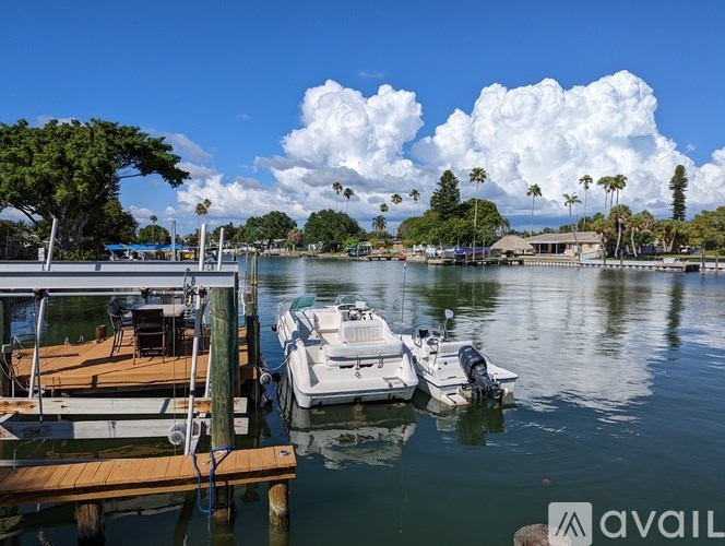 A dock with boats and a cloudy sky.