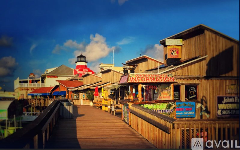 A wooden pier with a lighthouse and a sign that says "Information".