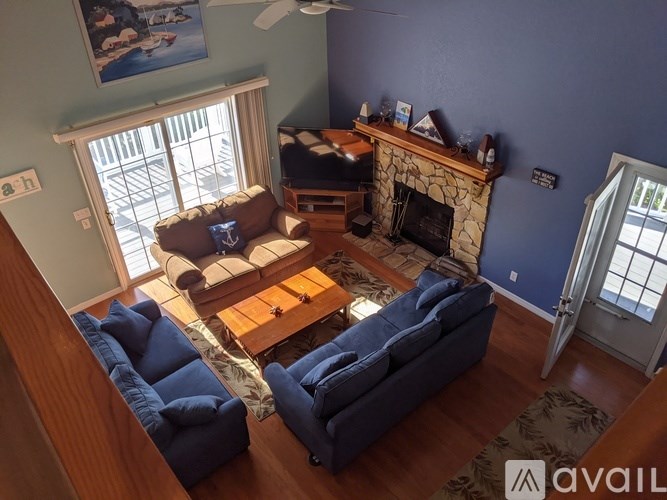 A living room with a fireplace and a painting on the wall.