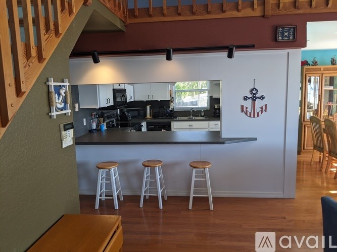 A kitchen with a bar and stools.