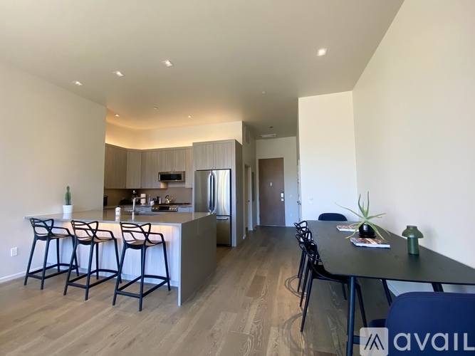 A modern kitchen with a bar area and a dining table.