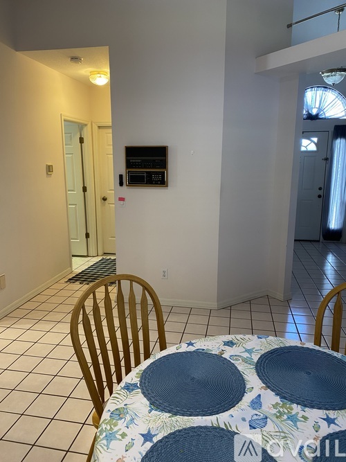 A dining room with a table and chairs.