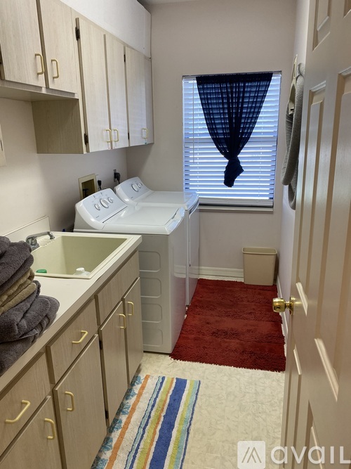 A small kitchen with a sink and a window.