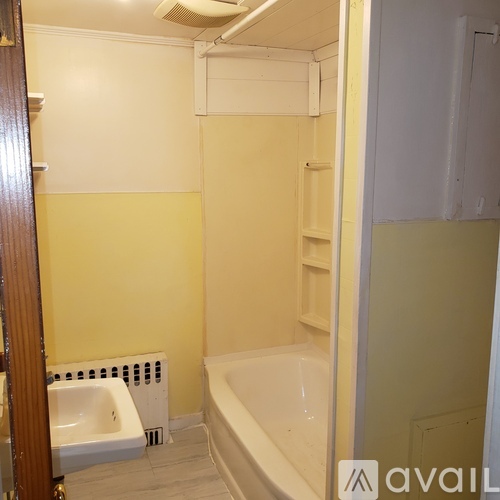 A bathroom with a white tub and a white sink.