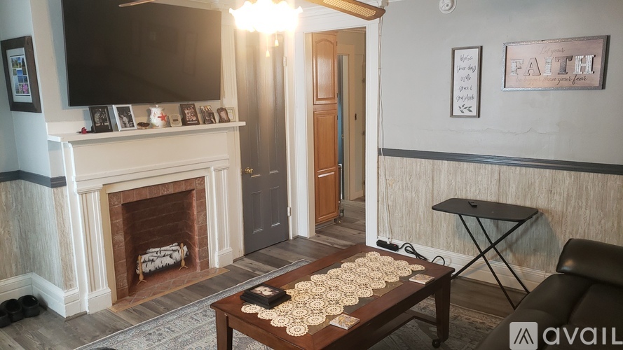 A living room with a fireplace, a sofa, and a coffee table.