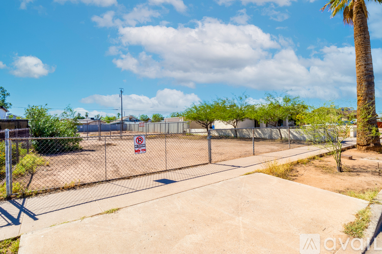 A fenced area with a "No Trespassing" sign in the foreground.
