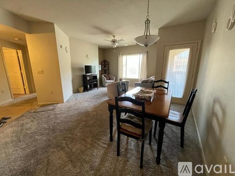 A living room with a dining table and chairs.