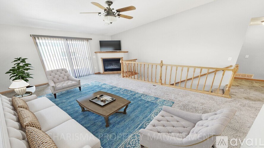 A living room with a white couch, a coffee table, and a ceiling fan.