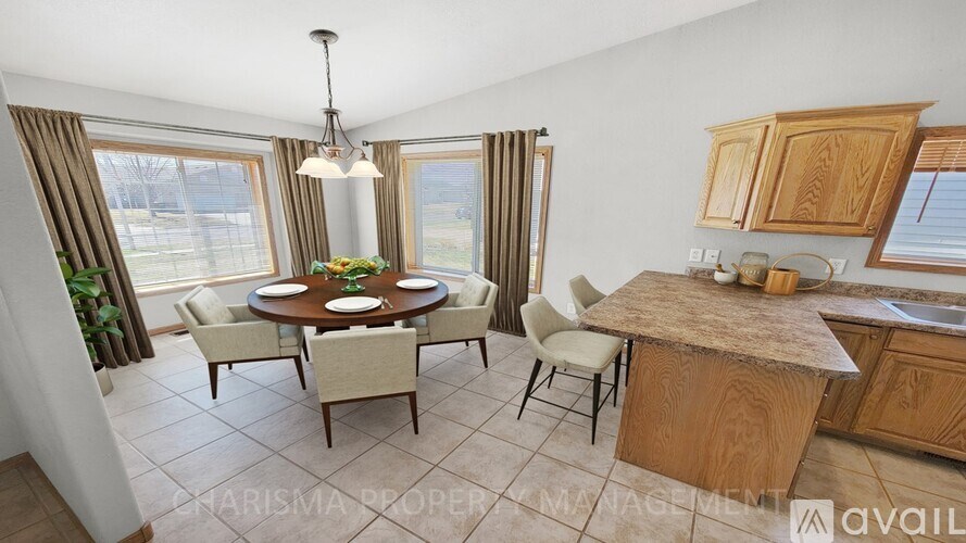 A dining room with a round table and chairs.