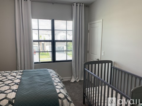 A bedroom with a bed and a crib.