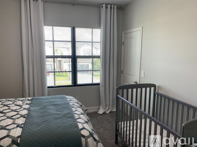 A bedroom with a bed and a crib.