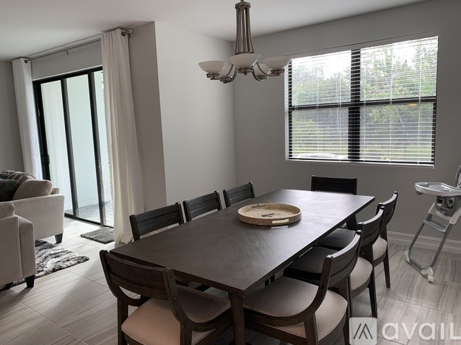 A dining room with a wooden table and chairs.