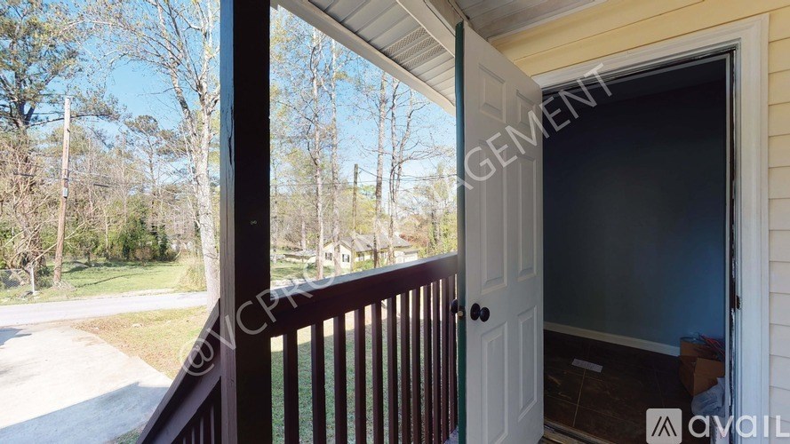 A view from a house looking out to a tree-lined street.