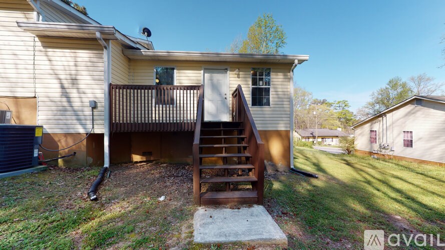 A house with a wooden staircase leading to the second floor.