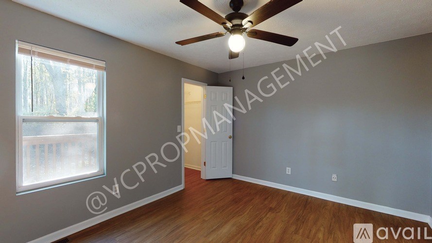 A room with a ceiling fan and a window.