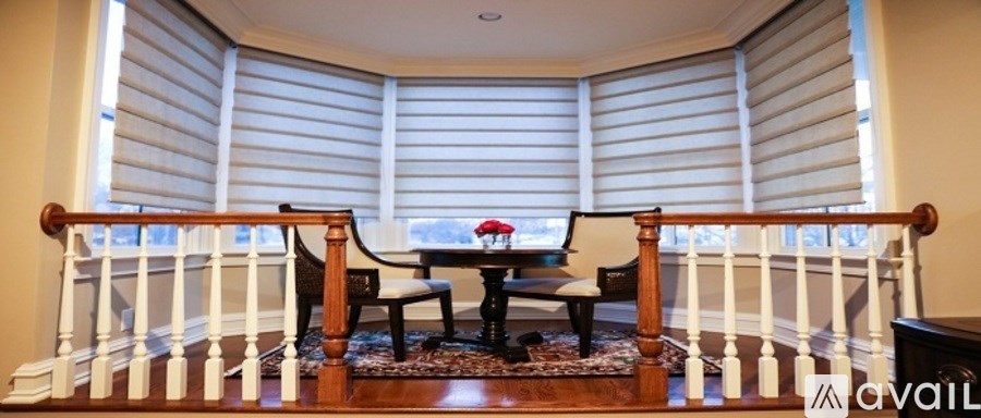 A dining room with a table and chairs.