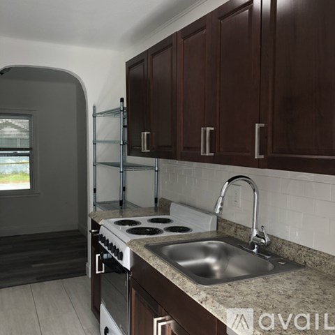 A kitchen with a stove top oven and a sink.