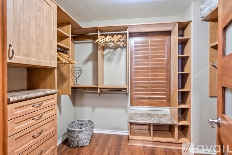 A room with wooden furniture and a basket on the floor.