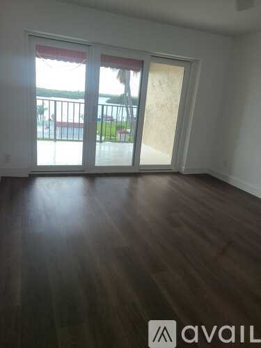 A room with wooden floors and a sliding glass door.
