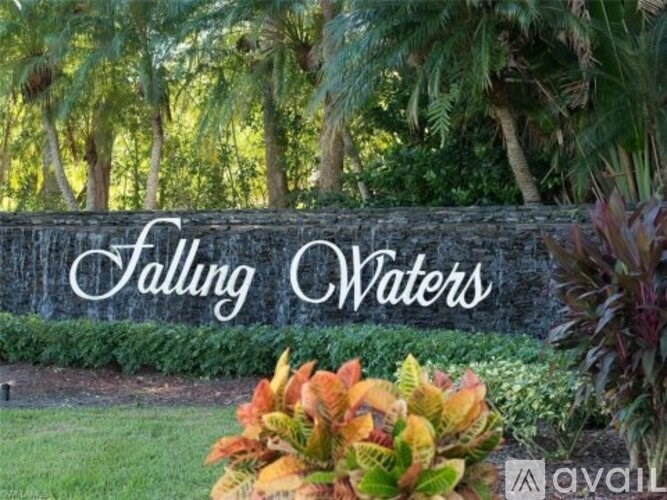 A sign that says "Falling Waters" is in front of some trees.