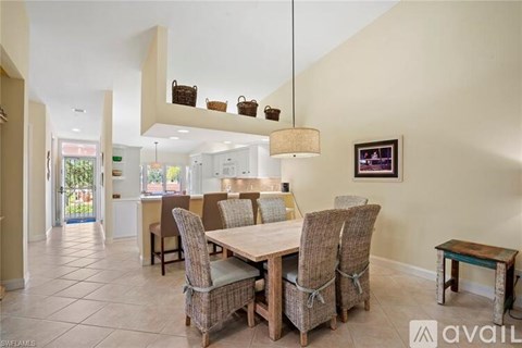 A dining room with a table and chairs.
