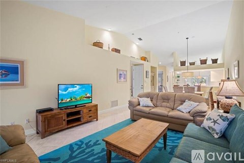 A living room with a television and a couch.