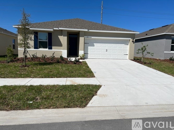 A house with a garage and a driveway in front.