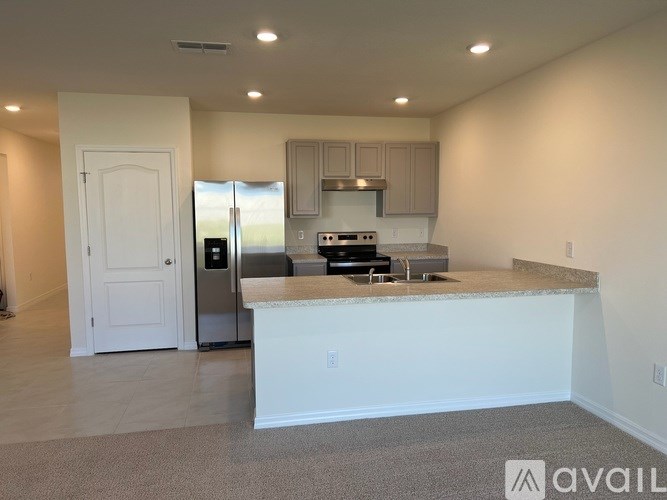 A kitchen with a white door and a white countertop.