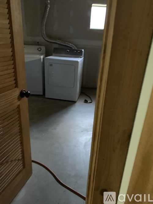 A bathroom with a toilet, sink and a window.