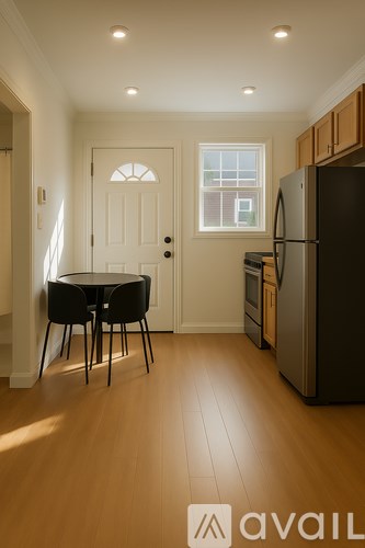 A kitchen with a table and chairs and a refrigerator.