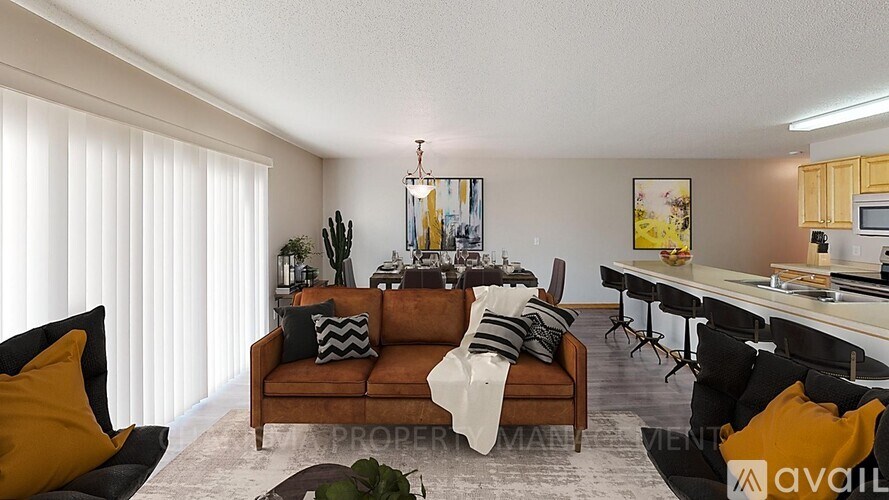 A living room with a brown couch and a coffee table.