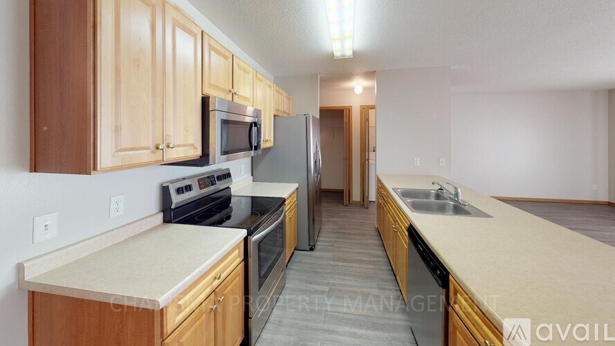 A kitchen with wooden cabinets and a white countertop.