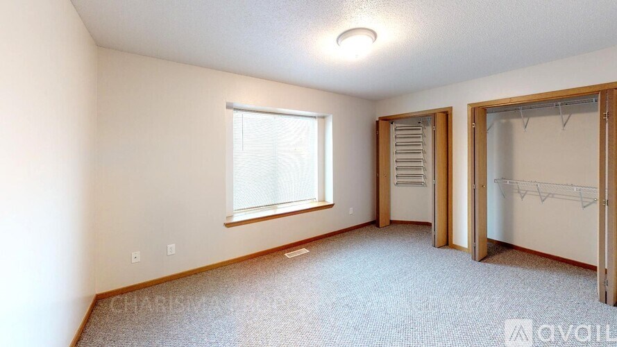 A room with a window and a door is available for rent.