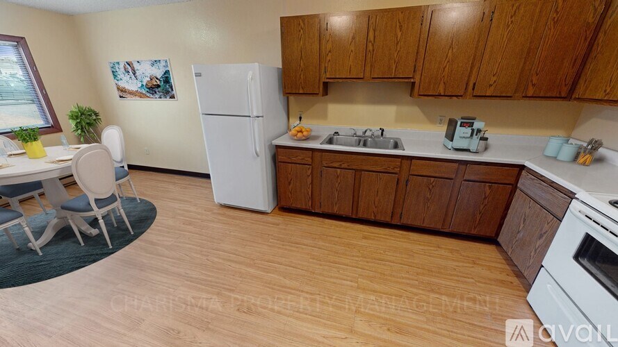 A kitchen with wooden cabinets and a white fridge.