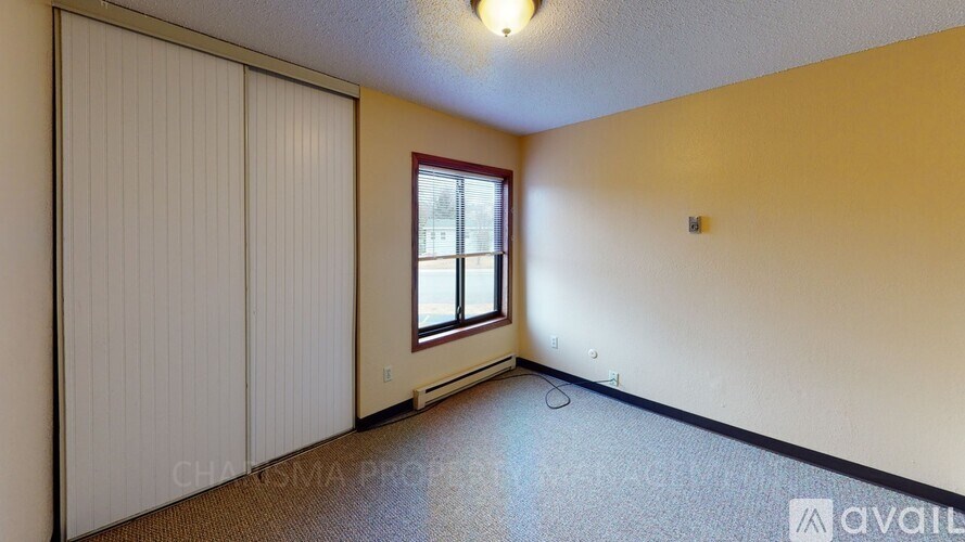 A room with a window and a closed door.