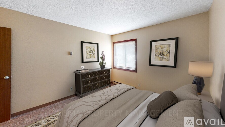 A bedroom with a bed, dresser, and two framed pictures on the wall.