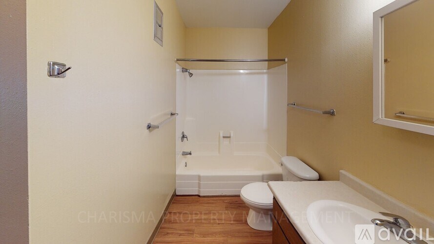 A bathroom with a toilet, sink, and bathtub.