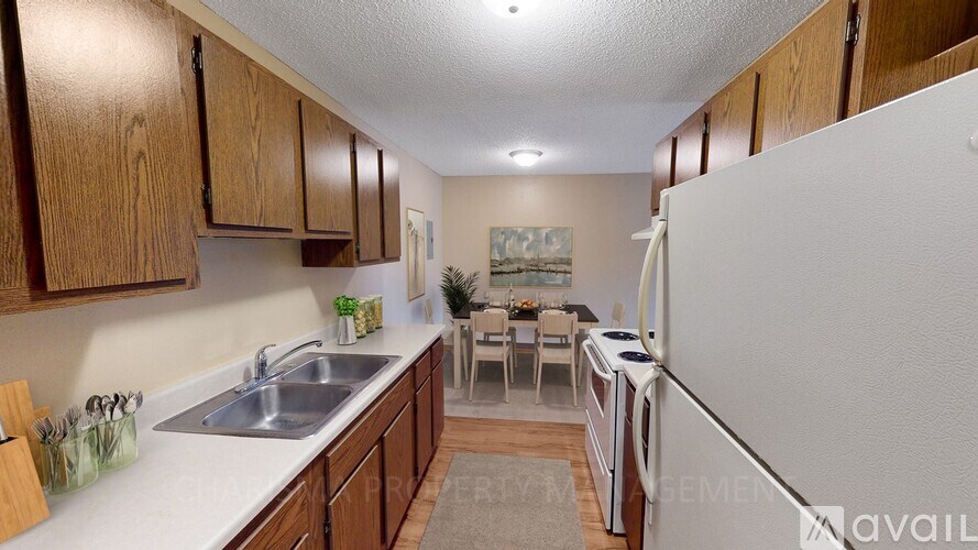 A kitchen with wooden cabinets and a white refrigerator.