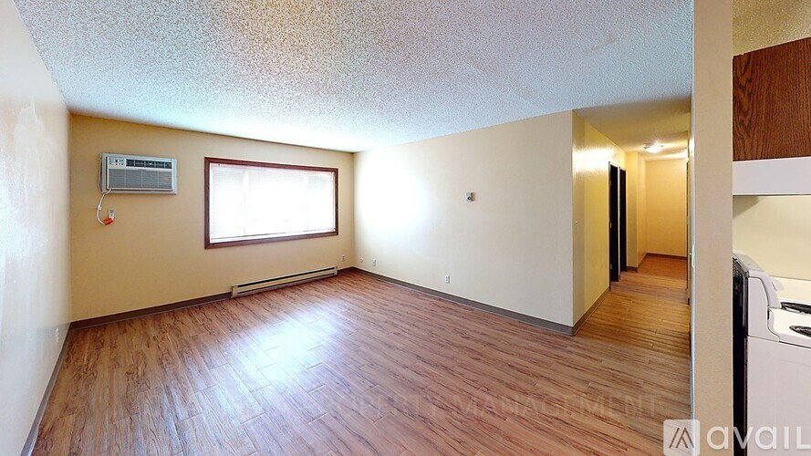 A room with wooden flooring and a window.