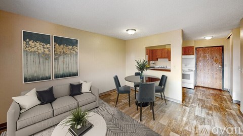 A living room with a grey couch and a coffee table.