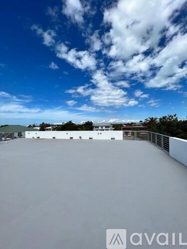 A rooftop with a clear sky and clouds.