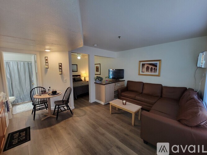 A living room with a brown couch and a wooden coffee table.