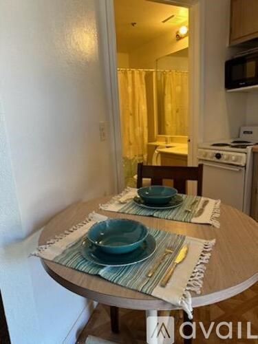 A table with two plates on it in a kitchen.