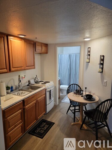 A kitchen with wooden cabinets and a white oven.
