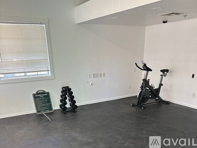 A room with a stationary bike and a sign that says "FURNISHED".
